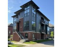 Stunning modern townhouse with mixed brick and sleek gray siding, large windows, and an inviting entry stairway at 247 Poplar St, Westfield, IN 46074