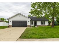 Charming single-story home with a dark garage door and well-maintained front yard at 321 Virginia St, Fortville, IN 46040