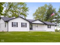 Charming single-story home with a sprawling front lawn, a covered porch and a American flag at 4605 S 150 W, Columbus, IN 47201