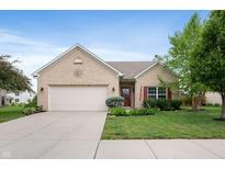 Charming brick home featuring a well-manicured lawn, attached two car garage, and a welcoming front entrance at 5576 W Glenview Dr, McCordsville, IN 46055