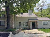 Charming home with a stone accent wall and a mature tree in the front yard at 5711 Bradston Way, Indianapolis, IN 46237