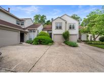 Charming townhome featuring an attached two-car garage, well-maintained landscaping, and a cozy, inviting facade at 6263 Behner Way, Indianapolis, IN 46250