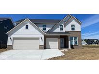 New construction home showcasing a three-car garage, stylish brick accents, and modern architectural details at 6450 Stone Side Dr, Plainfield, IN 46168