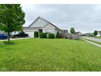 Charming single-story home with a well-maintained lawn, truck in driveway, and attractive landscaping at 7515 Brattle Dr, Indianapolis, IN 46113