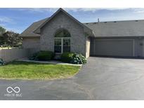 Charming brick home with lush landscaping and a two-car garage at 7548 Briarstone Dr, Indianapolis, IN 46227