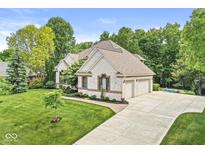 Charming two-story house with a well-manicured lawn, mature trees, and a spacious driveway leading to a two-car garage at 790 Foxboro Dr, Avon, IN 46123