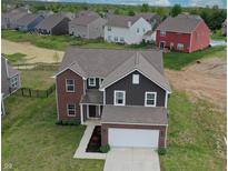 Beautiful home with a brick and siding exterior, well-manicured lawn, and a two-car garage at 808 Capricorn Dr, Franklin, IN 46131