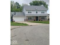 Charming two-story home with a covered front porch and an attached two-car garage at 922 Eagle Brook Dr, Shelbyville, IN 46176