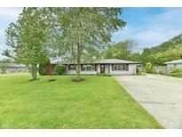 Charming single-story home featuring a well-manicured front lawn and mature shade trees at 11309 N County Road 750 W, Elwood, IN 46036