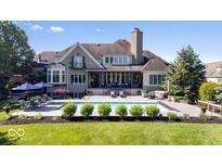 Inviting backyard with a sparkling pool, comfortable seating, and a covered patio at 11404 Hanbury Manor Blvd, Noblesville, IN 46060