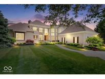 Beautiful two-story home showcasing manicured lawn and landscape at dusk at 11404 Hanbury Manor Blvd, Noblesville, IN 46060