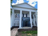 Welcoming building entrance with beautiful architectural details and manicured landscaping at 12853 Tradd St # 2B, Carmel, IN 46032