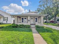 Charming single-story home features stone accents, manicured lawn, and a welcoming front porch at 145 S 7Th Ave, Beech Grove, IN 46107
