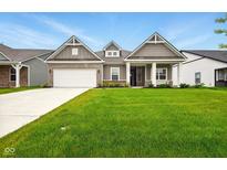 Charming home with a well-manicured lawn and a cozy front porch perfect for enjoying the outdoors at 19257 Red Willow Ln, Noblesville, IN 46062