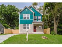 Charming two-story home with stone accents, green lawn, and colorful siding at 2429 N Centennial St, Indianapolis, IN 46222