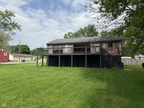 Charming home with a black foundation, and wooden deck overlooking a lush green yard at 258 Riverwood Dr, Noblesville, IN 46062