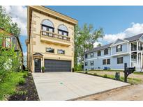 Stunning three-story home featuring a balcony and spacious driveway at 2841 Tropical Dr, Indianapolis, IN 46205
