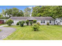 Charming single-story home with a well-manicured lawn and mature trees offering great curb appeal at 4244 Asbury St, Indianapolis, IN 46227