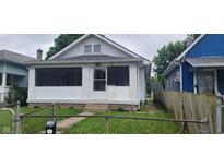 Charming home featuring white paint, a small front porch, and a fenced yard, ideal for first-time buyers at 427 N Alton Ave, Indianapolis, IN 46222