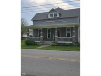 Charming two-story home featuring a welcoming front porch with stone pillars and a landscaped yard at 4303 W County Road 200 S Rd, Danville, IN 46122