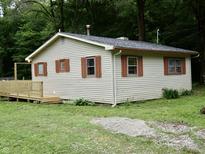 Charming home featuring lap siding, complemented by a wooden deck, and surrounded by lush green trees at 4675 N Herbemont Rd, Martinsville, IN 46151