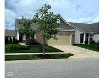 Charming single-Gathering home featuring a brick facade, attached two-car garage, and a well-manicured lawn at 4960 Silverbell Dr, Plainfield, IN 46168
