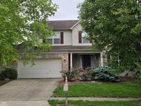 Charming two-story home featuring a two-car garage, inviting front porch, and beautifully landscaped front yard at 5305 Potomac Ln, Greenwood, IN 46142