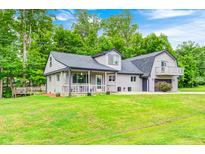 Charming home exterior with a well-maintained lawn, lush landscaping, and a two-story design at 5739 Paradise Dr, Martinsville, IN 46151