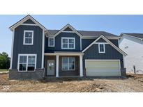 Charming two-story home with blue siding, white trim, and a brick base, offering a blend of modern and classic design at 6462 Stone Side Dr, Plainfield, IN 46168