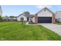 Charming single-story home with a well-maintained lawn and attached two car garage at 7319 Jackie Ct, Indianapolis, IN 46221