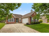 Charming single-story brick home with a well-manicured lawn and inviting curb appeal at 8084 Lawrence Woods Pl, Indianapolis, IN 46236