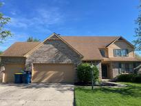 Charming two-story brick home featuring a spacious two-car garage and beautiful landscaping at 8400 Harrison Pkwy, Fishers, IN 46038