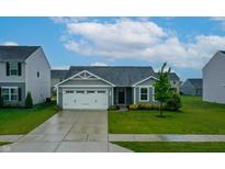 Charming single-story home featuring a two-car garage and a well-manicured front lawn at 9829 Hulton Rd, Pendleton, IN 46064