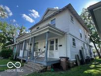 Classic two-story home featuring a covered porch, neutral siding, and inviting curb appeal at 1304 Franklin St, Columbus, IN 47201