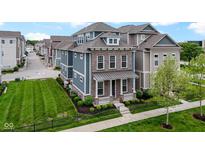 Beautiful two-story home with brick and siding, manicured lawn, and black metal fence at 13048 Minden Dr, Fishers, IN 46037