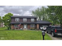 Charming two-story home with brick and wood facade, a well-kept lawn, and an attached garage at 131 Creek View Ct, Greenfield, IN 46140