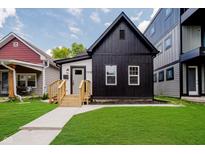 Charming renovated home with striking black and white exterior, modern design, and inviting curb appeal at 1318 Hoyt Ave, Indianapolis, IN 46203