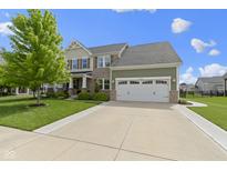 Charming two-story home with stone and siding, showcasing a well-maintained lawn and driveway at 13485 Mancroft Dr, Fishers, IN 46037