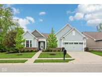 Charming single-Gathering home showcasing its manicured lawn and attached two-car garage at 14458 Carlow Run, Carmel, IN 46074