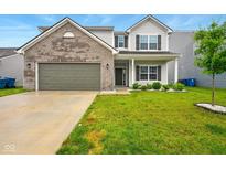 Charming two-story home with a gray brick facade, lush green lawn, and attached two-car garage at 1454 Silver Pine Ln, Sheridan, IN 46069
