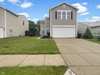 Charming two-story home featuring a well-maintained lawn, concrete driveway, and inviting curb appeal at 15110 Fawn Hollow Ln, Noblesville, IN 46060