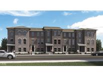 Charming brick townhomes with sidewalks enhance curb appeal on a sunny day at 17717 Remy Rd, Noblesville, IN 46062
