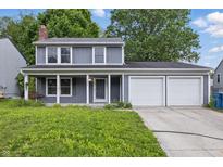 Charming two-story home with a three car garage and well-manicured front lawn at 1826 Shorter Dr, Indianapolis, IN 46214