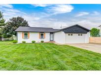 Charming single-story home with well-manicured lawn and attached two car garage at 203 Leerkamp Dr, Franklin, IN 46131