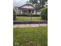 Charming single-Gathering home with a well-maintained front yard and classic architectural details at 2037 Houston St, Indianapolis, IN 46218