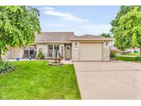 Charming brick home with a well-manicured lawn and an inviting front porch perfect for relaxing at 2044 Flamingo Way, Franklin, IN 46131