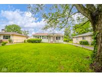 Charming single-story home with a well-manicured lawn and mature tree at 2726 Apache Dr, Anderson, IN 46012