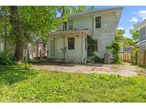 View of the home's backyard with a concrete patio and grassy area at 3134 N College Ave, Indianapolis, IN 46205