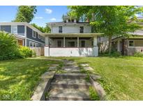 Charming two-story home with a welcoming front porch and well-maintained lawn at 3134 N College Ave, Indianapolis, IN 46205