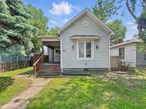 Charming home featuring a quaint front porch and well-maintained lawn at 401 Harlan St, Indianapolis, IN 46201